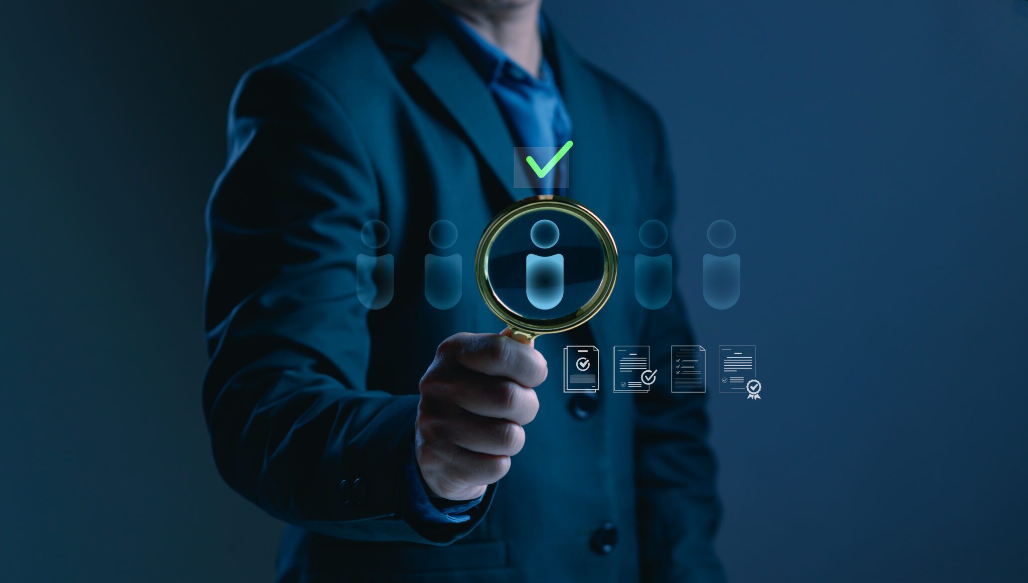 Businessman hand using magnifying glass to select qualified candidate representing recruitment, talent acquisition, hiring process, employee selection, human resources and HR recruitment solutions